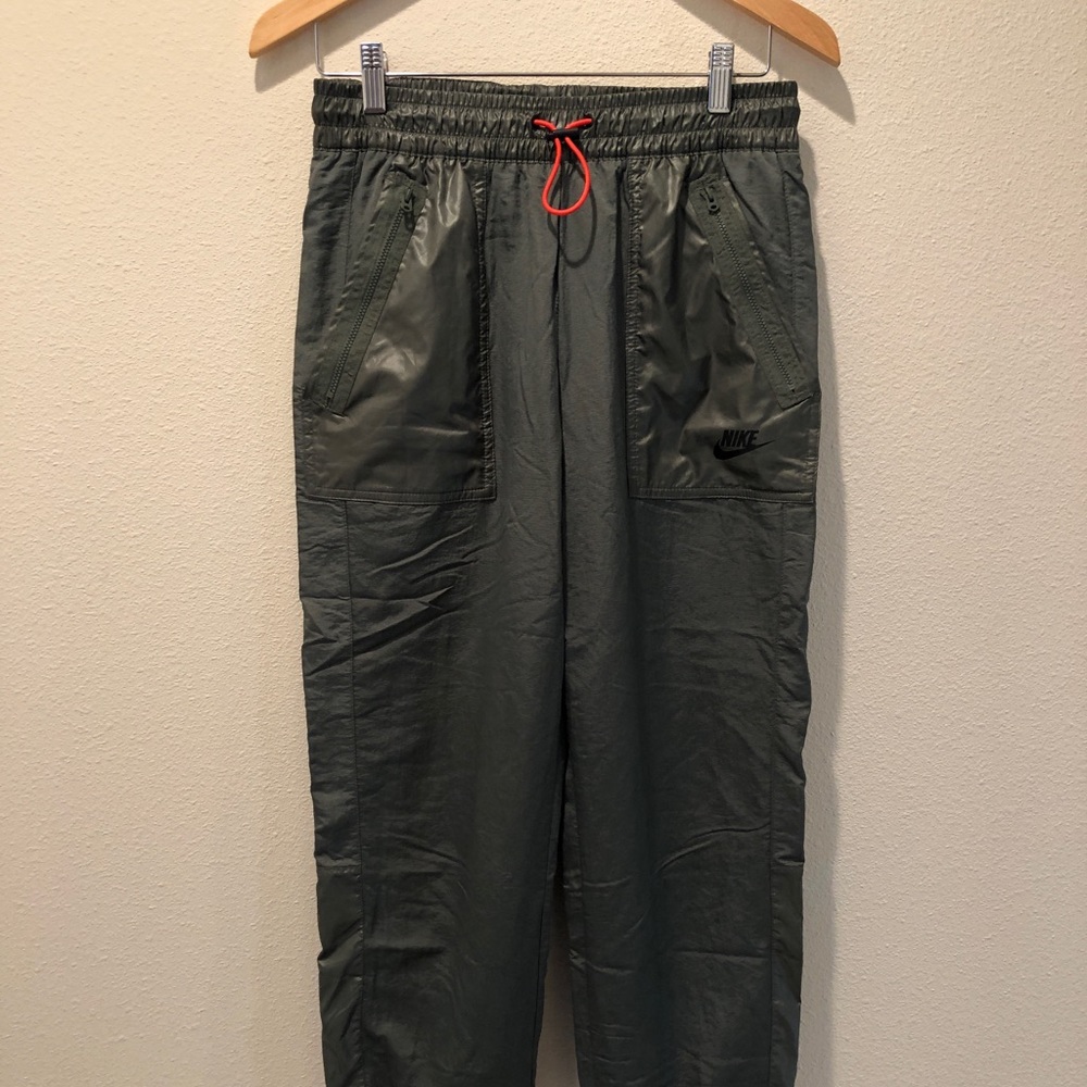 Women’s woven Nike sportswear pants.
